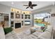 Inviting living room featuring a fireplace, built-in shelves, and seamless access to the outdoor pool area at 9012 Province St, Sarasota, FL 34240