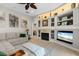 Comfortable living room with a fireplace, built-in shelves, and stylish decor for relaxation and entertainment at 9012 Province St, Sarasota, FL 34240