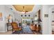 Well-decorated living room with a unique rug, tray ceiling, comfortable seating, and pool view at 9012 Province St, Sarasota, FL 34240