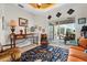Bright living room with eclectic decor, a statement rug, and sliding doors that lead to a beautiful outdoor space at 9012 Province St, Sarasota, FL 34240