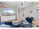 Comfortable living room with large television, blue couches, and neutral decor at 9012 Province St, Sarasota, FL 34240