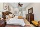 Well-lit main bedroom with a king-size bed, dresser, and access to closet space and en-suite bathroom at 9012 Province St, Sarasota, FL 34240