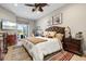 Spacious main bedroom featuring a king-size bed, stylish decor, and a patio door leading to the outdoor area at 9012 Province St, Sarasota, FL 34240