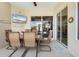 Screened patio with table and chairs, slider to the interior, plus outdoor decoration at 9012 Province St, Sarasota, FL 34240