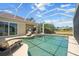 Beautiful screened pool area with outdoor kitchen, lounge chairs, and a relaxing spa at 9012 Province St, Sarasota, FL 34240