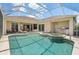 Screened pool with spa and outdoor kitchen provides a private oasis for relaxation and entertainment at 9012 Province St, Sarasota, FL 34240