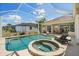 Screened pool with spa and outdoor kitchen provides a private oasis for relaxation and entertainment at 9012 Province St, Sarasota, FL 34240