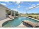 Beautiful screened pool area with outdoor kitchen, lounge chairs, and a relaxing spa at 9012 Province St, Sarasota, FL 34240