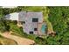Aerial view featuring a solar-paneled roof, screened pool, complemented by verdant landscaping at 9915 Old Hyde Park Pl, Bradenton, FL 34202