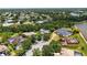 Expansive aerial view showcasing the neighborhood's lush landscaping, mature trees and lake at 9915 Old Hyde Park Pl, Bradenton, FL 34202