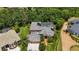 Aerial view of private backyard pool and home surrounded by lush greenery and mature trees at 9915 Old Hyde Park Pl, Bradenton, FL 34202