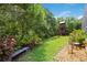 Private backyard with lush landscaping, mature trees, and a playhouse, perfect for outdoor enjoyment at 9915 Old Hyde Park Pl, Bradenton, FL 34202