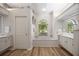Bright bathroom featuring a soaking tub, a view to the outside, and a vanity at 9915 Old Hyde Park Pl, Bradenton, FL 34202