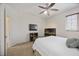 Minimalist bedroom featuring a ceiling fan, flatscreen television, and a decorative fish tank at 9915 Old Hyde Park Pl, Bradenton, FL 34202