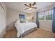 Cozy bedroom with a comfortable queen-size bed, ceiling fan, and bright natural light at 9915 Old Hyde Park Pl, Bradenton, FL 34202