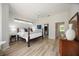 Spacious main bedroom with wood-look flooring, ceiling fan, and walk-in closet at 9915 Old Hyde Park Pl, Bradenton, FL 34202