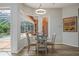 Breakfast nook features a glass table, pool views, and modern lighting at 9915 Old Hyde Park Pl, Bradenton, FL 34202