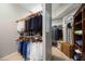 Custom walk-in closet with ample hanging space and built-in shelving at 9915 Old Hyde Park Pl, Bradenton, FL 34202