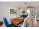 Dining area features a wooden table, decorative lighting, and stylish chairs at 9915 Old Hyde Park Pl, Bradenton, FL 34202