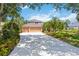 A view of the exterior featuring a spacious driveway and a well-maintained three-car garage at 9915 Old Hyde Park Pl, Bradenton, FL 34202
