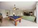 The game room includes a pool table, a comfortable sofa, and an entertainment center at 9915 Old Hyde Park Pl, Bradenton, FL 34202
