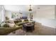 Spacious game room with a pool table, large sectional sofa, and cozy carpet at 9915 Old Hyde Park Pl, Bradenton, FL 34202