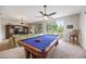 Large game room showcases a pool table with outdoor views and a comfortable seating area at 9915 Old Hyde Park Pl, Bradenton, FL 34202