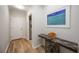 Hallway featuring a marble-topped console table and neutral walls at 9915 Old Hyde Park Pl, Bradenton, FL 34202