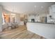 Open-concept kitchen with white cabinetry, breakfast bar, and modern appliances at 9915 Old Hyde Park Pl, Bradenton, FL 34202