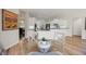 Bright, open kitchen featuring white cabinets, bar seating, and modern appliances at 9915 Old Hyde Park Pl, Bradenton, FL 34202