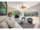 Comfortable living room area with large windows providing ample natural light and pool views at 9915 Old Hyde Park Pl, Bradenton, FL 34202