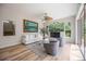Bright living room with big windows, providing plenty of natural light, ceiling fan, and pool views at 9915 Old Hyde Park Pl, Bradenton, FL 34202