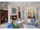 Comfortable living room features a fireplace, wood floors, and natural light from the entryway at 9915 Old Hyde Park Pl, Bradenton, FL 34202