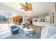 Living room with hardwood floors, modern furniture, and glass sliding doors leading to a patio at 9915 Old Hyde Park Pl, Bradenton, FL 34202