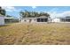 The backyard features a lush lawn and provides plenty of space for outdoor activities at 1007 Southern Pine Ln, Sarasota, FL 34243