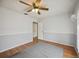 A cozy bedroom with a ceiling fan, wood floors, and neutral paint, offers a relaxing and private space at 1007 Southern Pine Ln, Sarasota, FL 34243