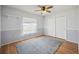 A well-lit bedroom with wood floors and soft decor, featuring a window and a double-door closet at 1007 Southern Pine Ln, Sarasota, FL 34243