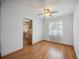 The dining room features wood flooring, a ceiling fan and view into the kitchen at 1007 Southern Pine Ln, Sarasota, FL 34243