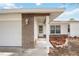 Welcoming home exterior featuring stone accents, a covered porch, and well-maintained landscaping at 1007 Southern Pine Ln, Sarasota, FL 34243