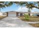 Charming one-story single Gathering home with a stone accent garage and mature landscaping at 1007 Southern Pine Ln, Sarasota, FL 34243