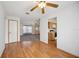 Spacious area features wood floors, ceiling fan, kitchen, and great natural light at 1007 Southern Pine Ln, Sarasota, FL 34243