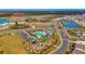 Aerial view of the community with amenities including a pool, playground, and green spaces, surrounded by homes at 10708 Tippecanoe Pl, Parrish, FL 34219