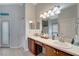 Bright bathroom featuring double sinks, a large mirror, and access to a private outdoor space at 11 Lateen Sail Dr, Placida, FL 33946