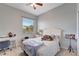 Well-lit bedroom with a ceiling fan, desk, and playful decor, creating a cheerful and inviting space at 11 Lateen Sail Dr, Placida, FL 33946