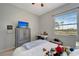 Bright bedroom featuring a TV, desk, and window offering a view of lush greenery, providing a relaxing retreat at 11 Lateen Sail Dr, Placida, FL 33946
