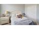 Cozy bedroom with a white headboard bed, nightstand, and a decorative lamp, offering a comfortable and peaceful ambiance at 11 Lateen Sail Dr, Placida, FL 33946