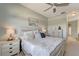 Comfortable bedroom with a ceiling fan, soft lighting, and stylish decor, creating a peaceful and inviting atmosphere at 11 Lateen Sail Dr, Placida, FL 33946