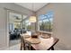 Dining area with a wooden table, pendant lighting, and sliding glass doors leading to an outdoor living space at 11 Lateen Sail Dr, Placida, FL 33946