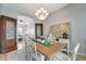 Dining room featuring an elegant chandelier, wood table with seating for six, and decorative display cabinets at 11 Lateen Sail Dr, Placida, FL 33946