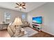 Inviting living room featuring a comfortable sectional sofa, a ceiling fan, and large windows for ample natural light at 11 Lateen Sail Dr, Placida, FL 33946